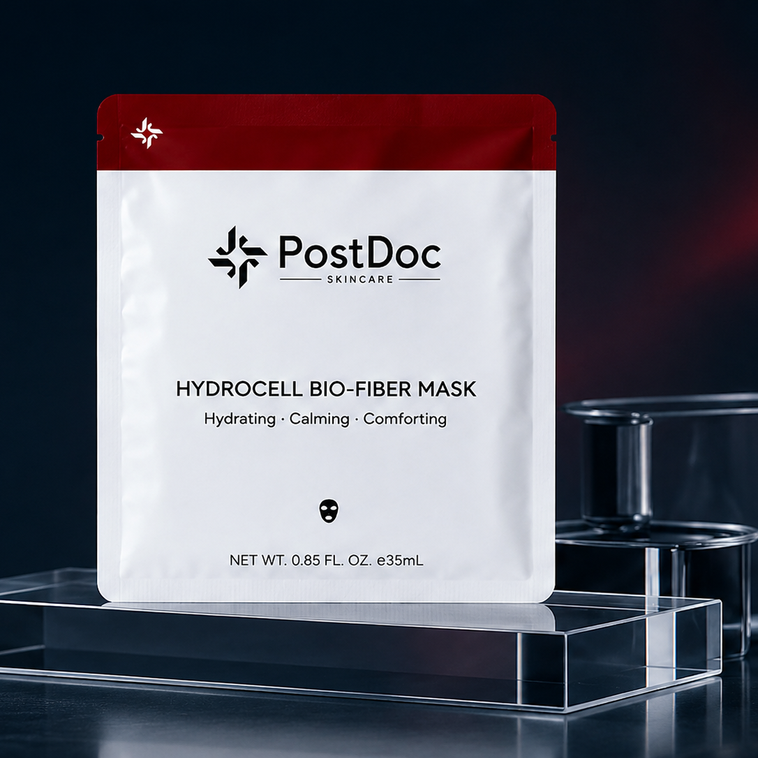PostDoc Skincare Hydrocell Bio-Fiber Mask packaging on a dark background with laboratory equipment.