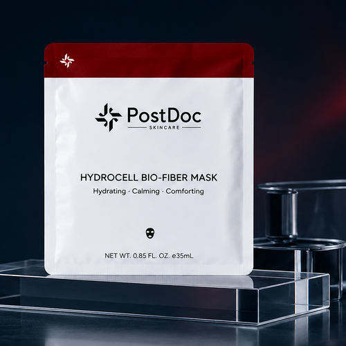 PostDoc Skincare Hydrocell Bio-Fiber Mask packaging on a dark background with laboratory equipment.